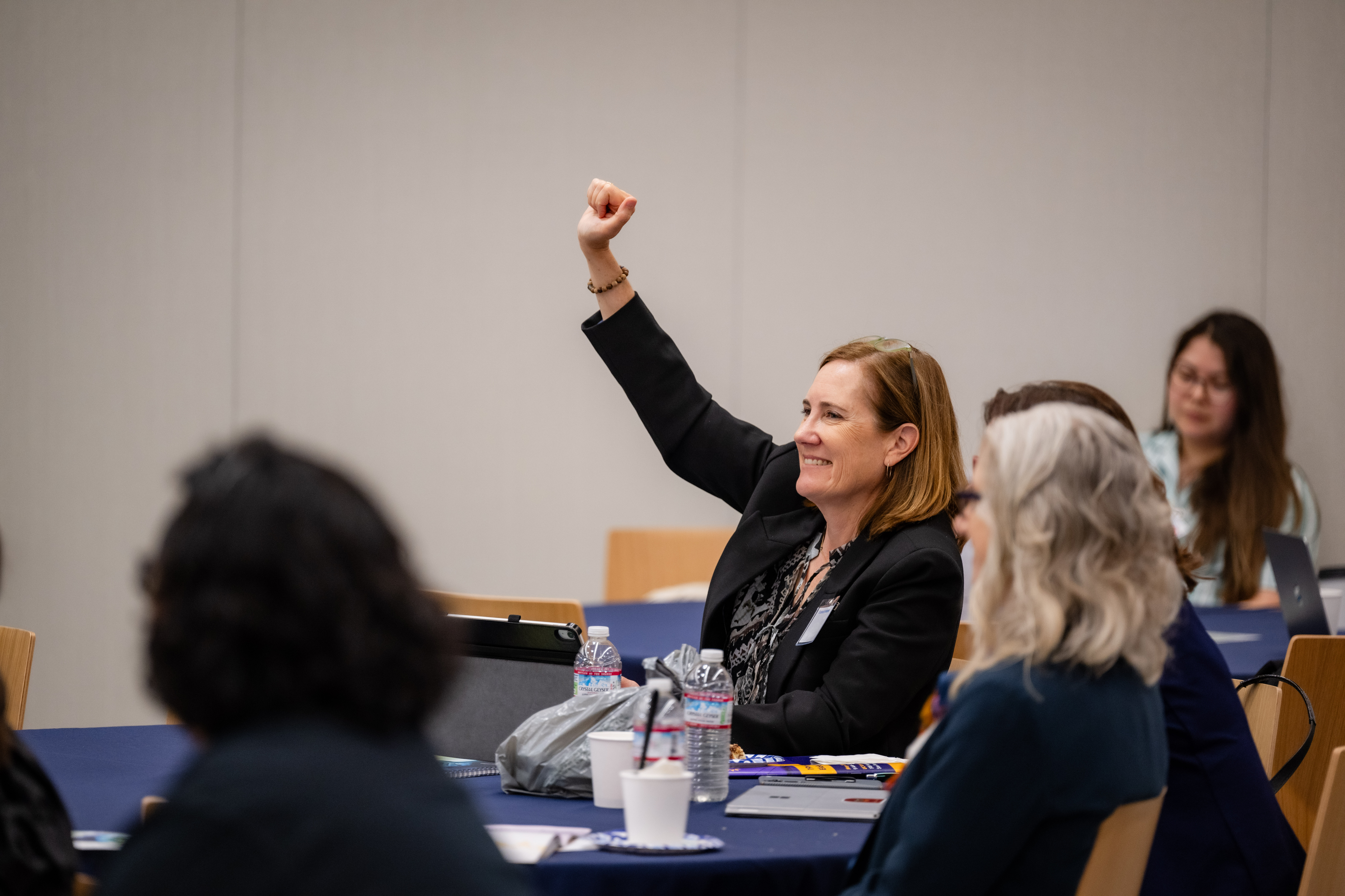 A smiling attendee at the A conference panel at the 19th Conference on Elder Abuse (May 2025)
